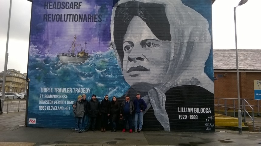 The Cuban artists in Hull in front of mural dedicated to women who fought for justice for fishing trawler workers